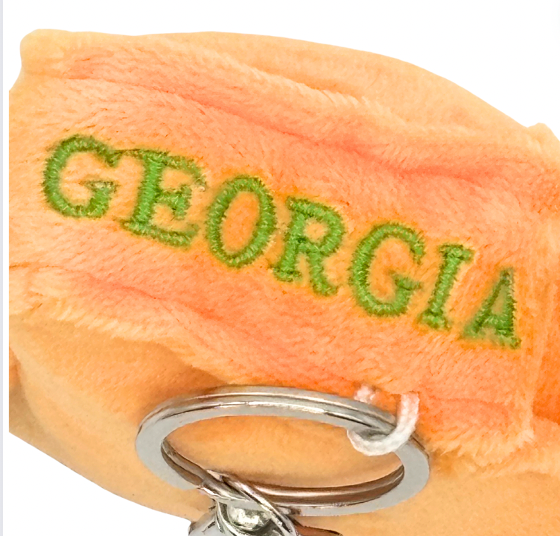 4-inch Georgia-shaped plush bag charm mini with a tiny peach, perfect for backpacks and keyrings with detailed stitching